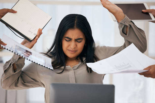 Woman pushing work away due to burnout and stress.