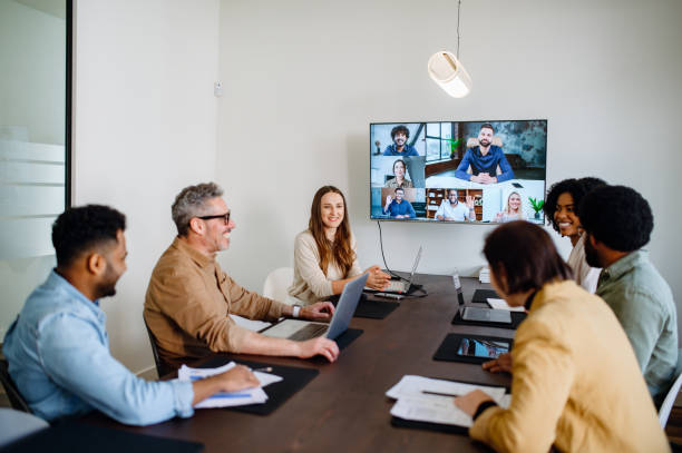 Half remote half in-office workers gather for a team meeting