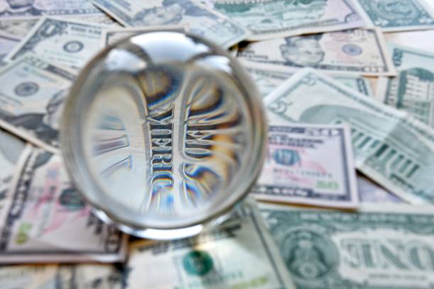 US dollar bill seen through a crystal ball.