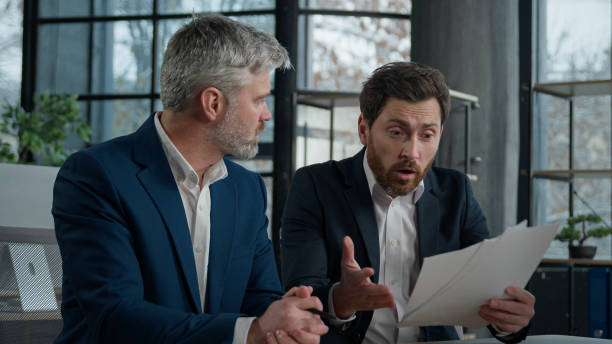 Employee venting to boss with piece of paper in hand