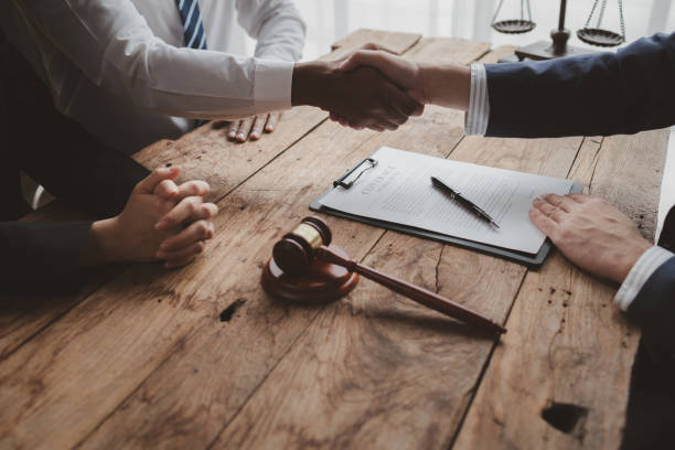 Lawyers give legal advice and shake hands with clients.