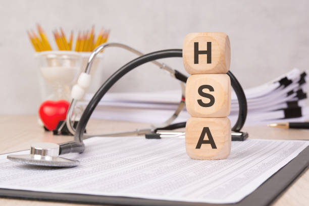 wooden cubes displaying HSA on a medical document with a stethoscope.