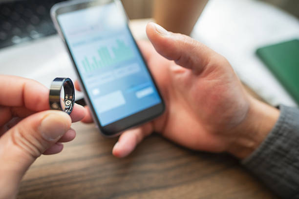 Man with smart ring indoors pairing to phone